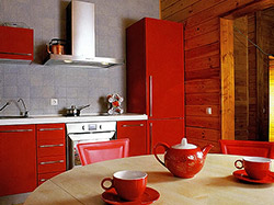 Насыщенный красный цвет кухонной мебели загородного дома